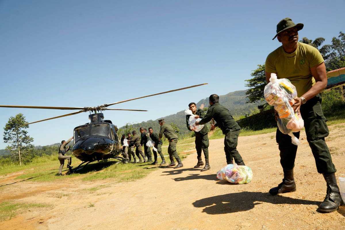 Sri Lanka Army soldiers unload relief material from a helicopter for flood victims following Cyclone Ditwah in Niyamgamdora, Sri Lanka, December 2, 2025 REUTERS/Akila Jayawardena